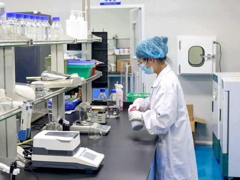 Technician operating supplement production equipment
